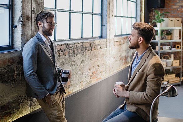 two businessman having a conversation in the office.