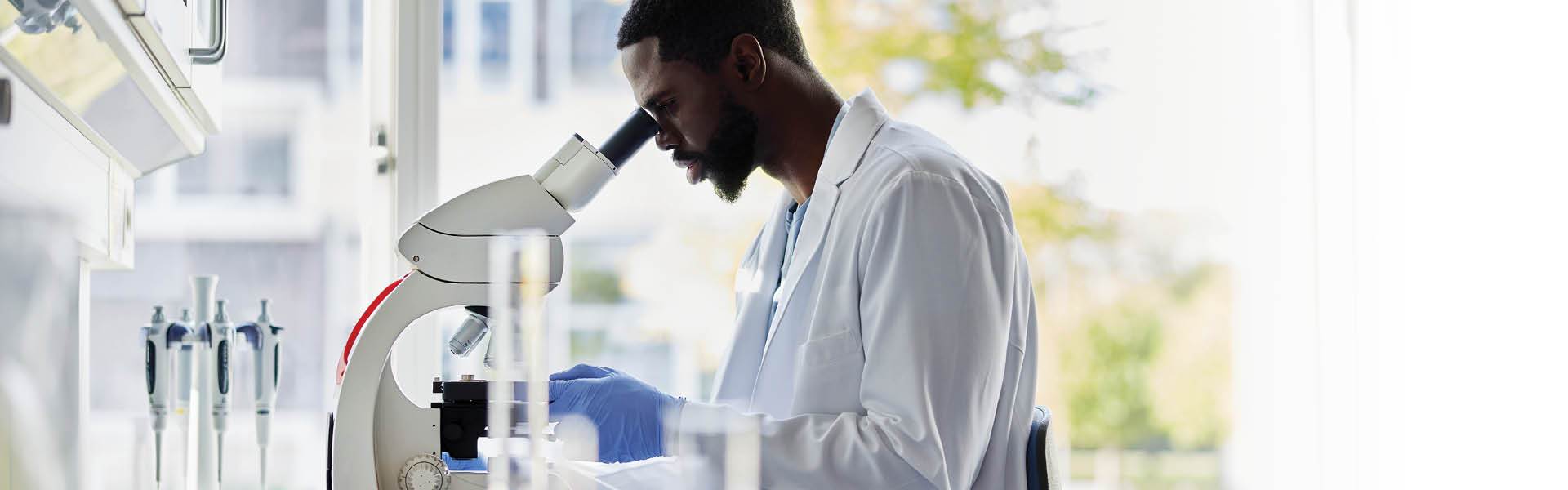 Doctor using a microscope.