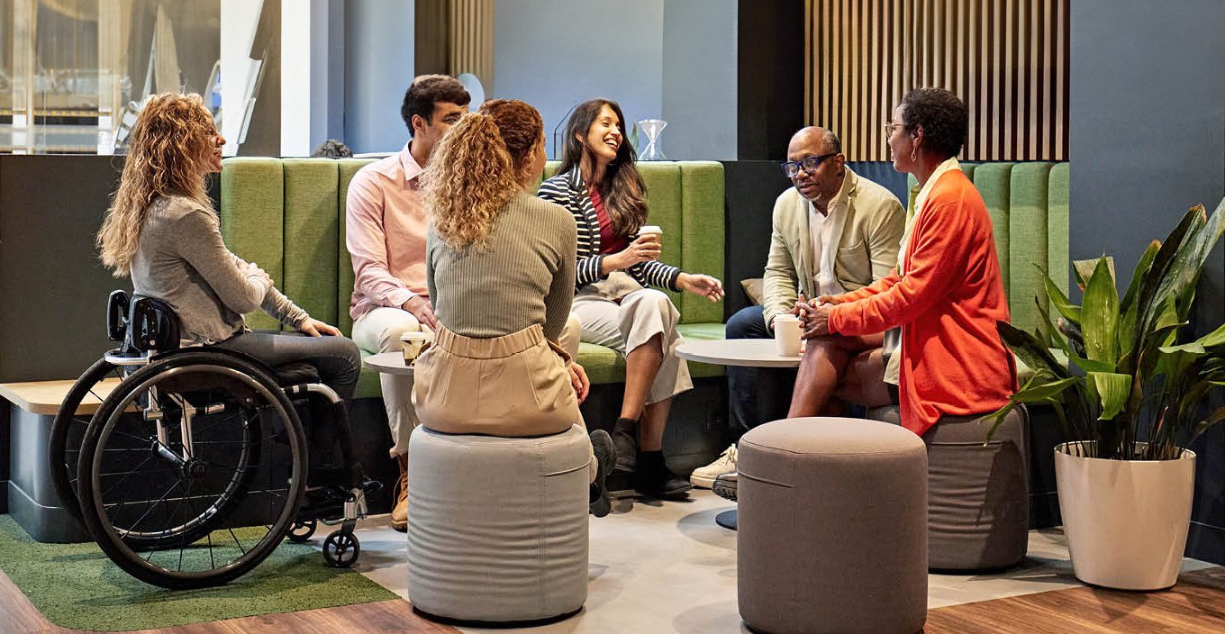 Diverse group of people seated enjoying conversation.