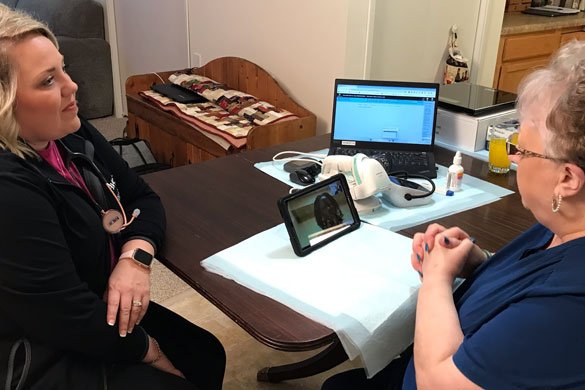 Hospital@Home patient Marva Chevalier (right), visits with Dr. Magdalene Fiddler virtually on the tablet, along with Bethlee Burke, nurse practitioner (left).