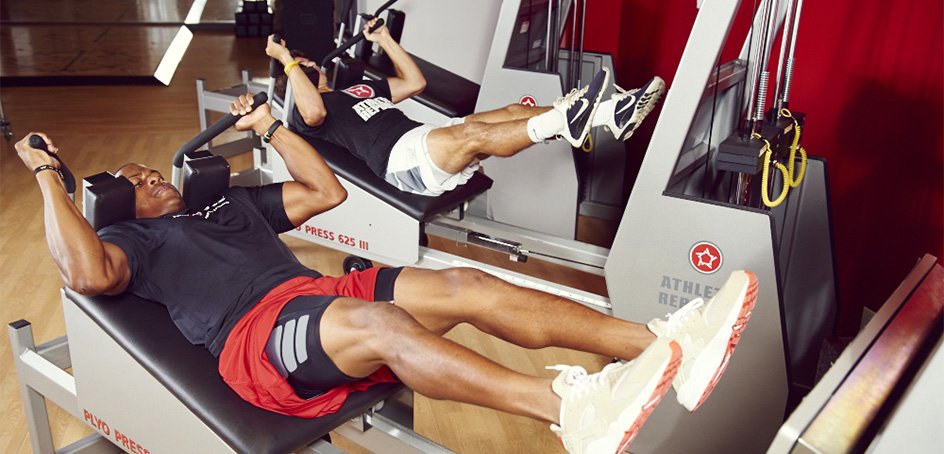 Two men exercising with a plyo press.