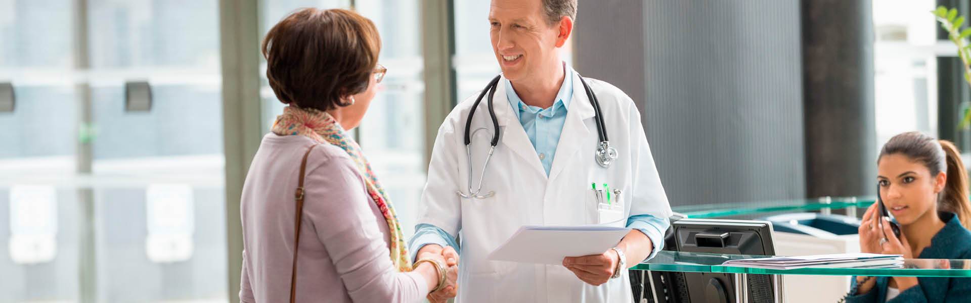 Doctor shaking the hand of a patient.