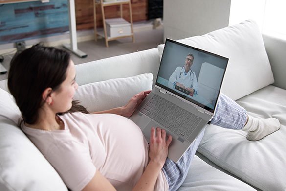 pregnant woman having telemedicine visit from home.