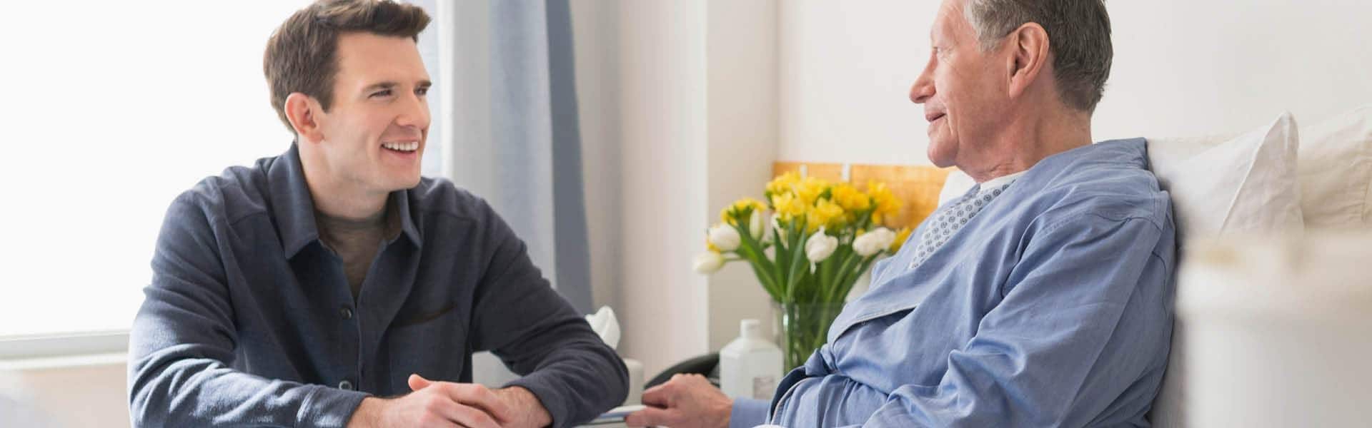 son visiting his father in a hospital.