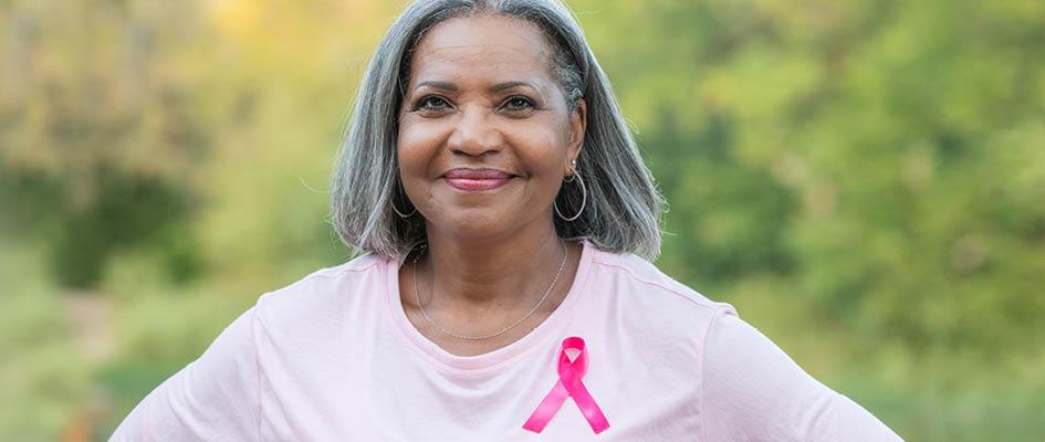 woman wearing pink shirt with pink ribbon.