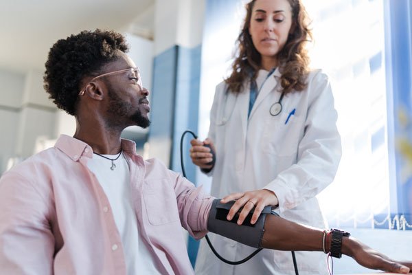 Doctor taking a patients blood pressure.