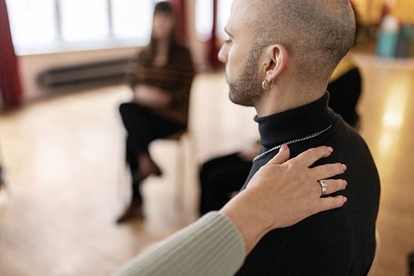 man sharing his story during a support session